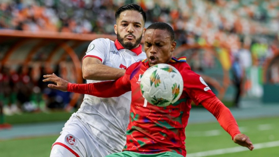 Wajdi Kechrida (L) of Tunisia and Riaan Hanamub of Namibia fight for possession.
