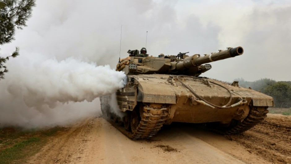 An Israeli battle tank moves along the border with the Gaza Strip