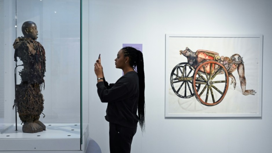 A statue stolen from a Congolose chief stands in the museum as "A Symbol of Stolen Art" as part of an exhibition highlighting the colonial-era plunder