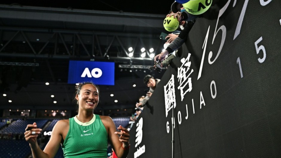 China's Zheng Qinwen signs autographs for fans after her victory against France's Oceane Dodin