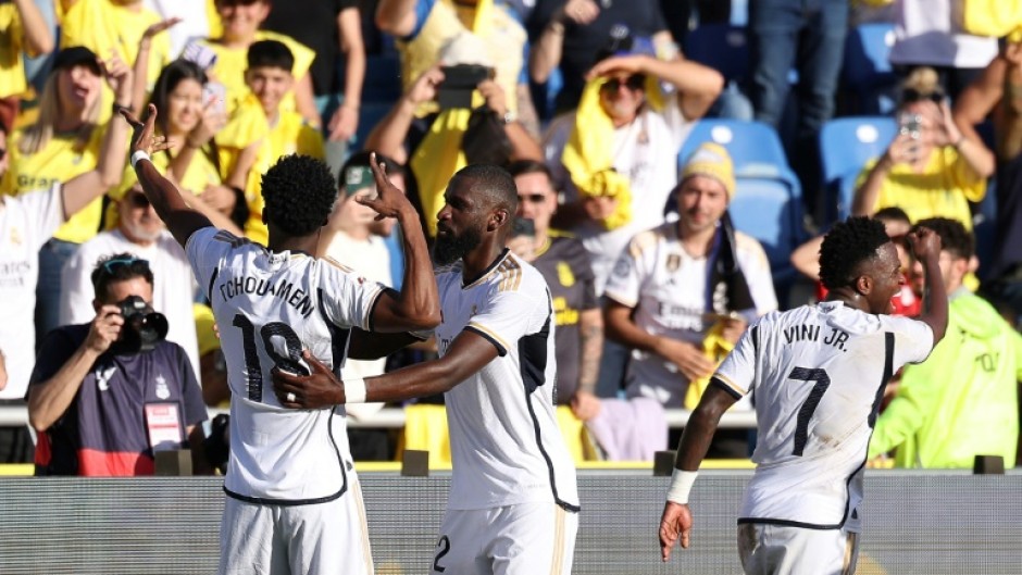 Real Madrid's French midfielder Aurelien Tchouameni (L) celebrates scoring the winner against Las Palmas to take his team top of La Liga