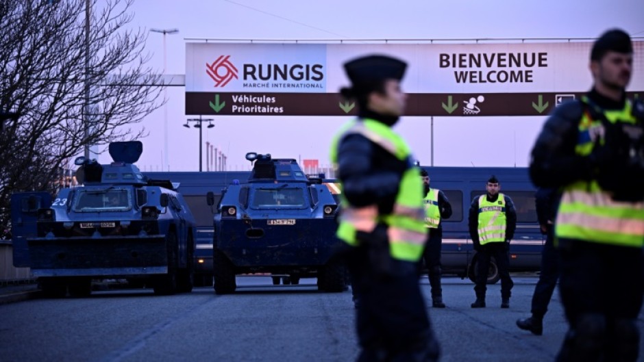 Gendarmes have parked armoured vehicles in front of the massive Rugnis wholesale food market outside Paris