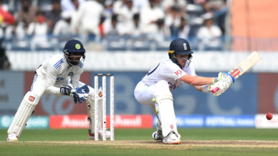 Ollie Pope lines up a reverse sweep as India's wicketkeeper Srikar Bharat watches 