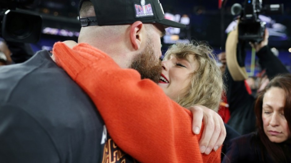 Kansas City tight end Travis Kelce shares a kiss with girlfriend Taylor Swift after the Chiefs booked a return to the Super Bowl with a victory over the Baltimore Ravens