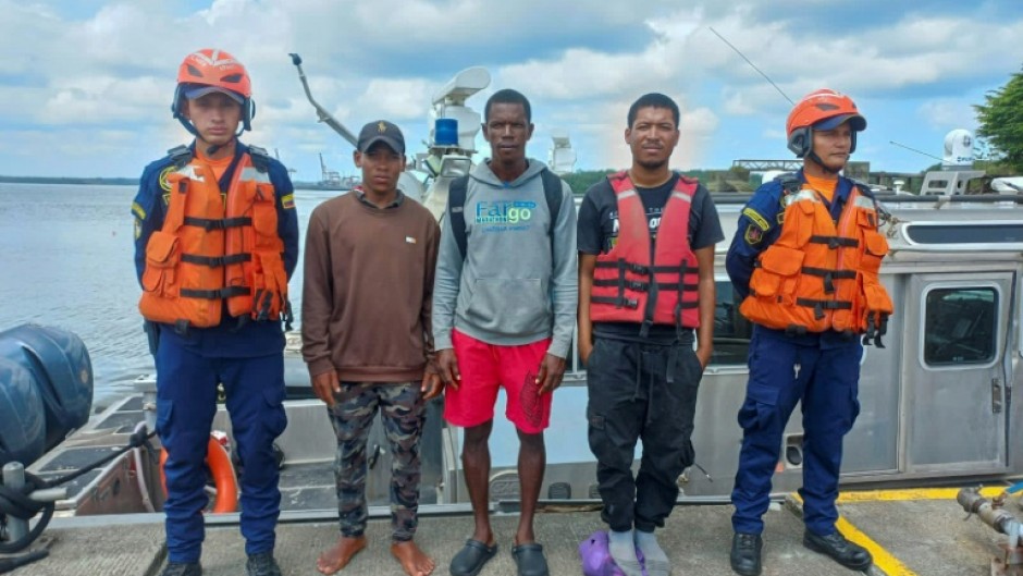 This photo released by the Colombian navy on 
February 2, 2024 shows sailors posing with three Panamanians who survived 11 days adrift in the Pacific Ocean