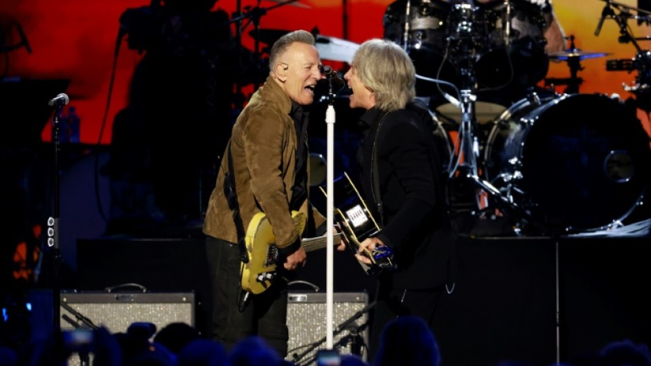 Jon Bon Jovi (R) and singer Bruce Springsteen (L) perform on stage during the 2024 MusiCares Person of the Year gala, which this year honored Bon Jovi