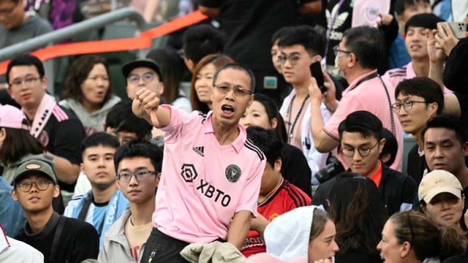 Angry fans in Hong Kong boo and give thumbs-down gestures after Lionel Messi failed to take the field in a sold-out and much-hyped friendly