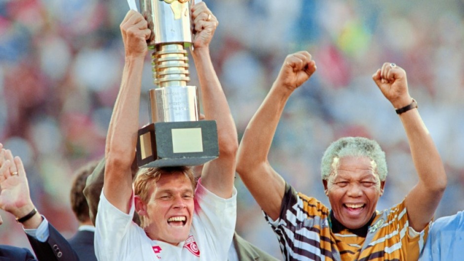 South Africa captain Neil Tovey lifts the Africa Cup of Nations trophy in 1996 as then President Nelson Mandela celebrates.  
