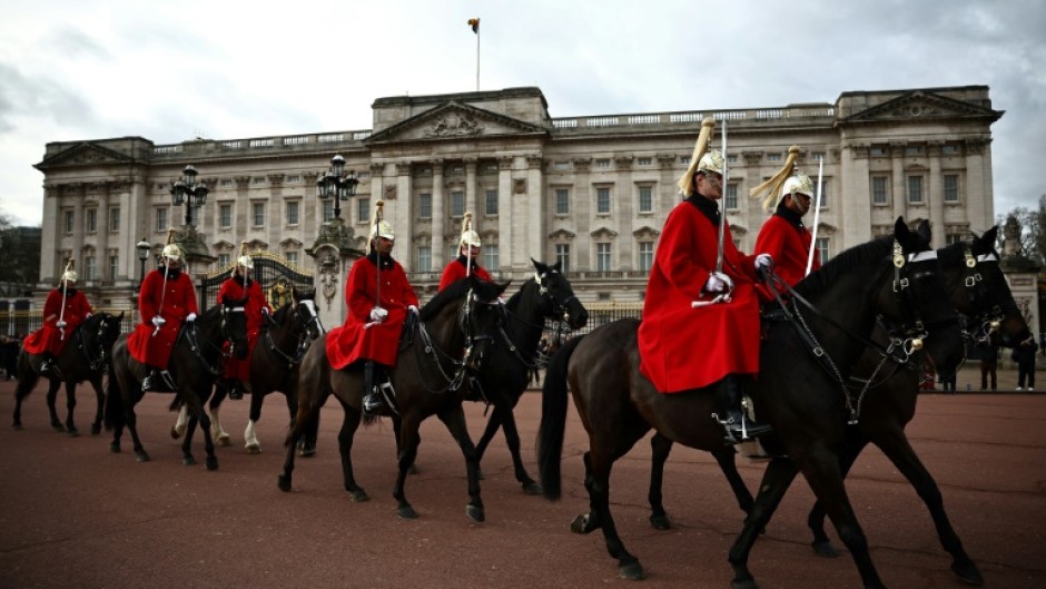 Life Guards, a unit of the Household Cavalry, ride their horses past Buckingham Palace the day after King Charles III began treatment for cancer