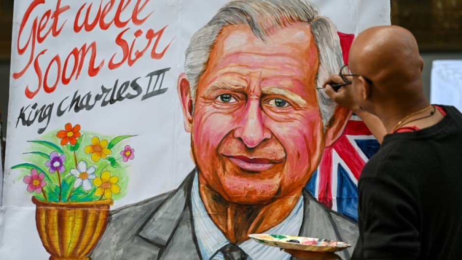 An artist finishes off a painting wishing Britain's King Charles III a speedy recovery