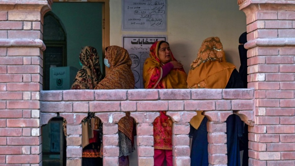 Women waiting to cast their ballot a polling station in Lahore