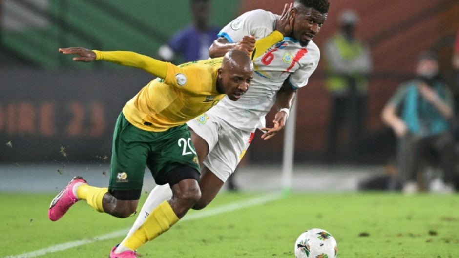 South Africa defender Khuliso Mudau (L) fights for the ball with DR Congo midfielder Aaron Tshibola