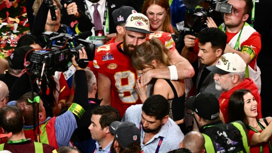 US singer-songwriter Taylor Swift and Kansas City Chiefs' tight end Travis Kelce embrace after the Chiefs' Super Bowl victory over the San Francisco 49ers