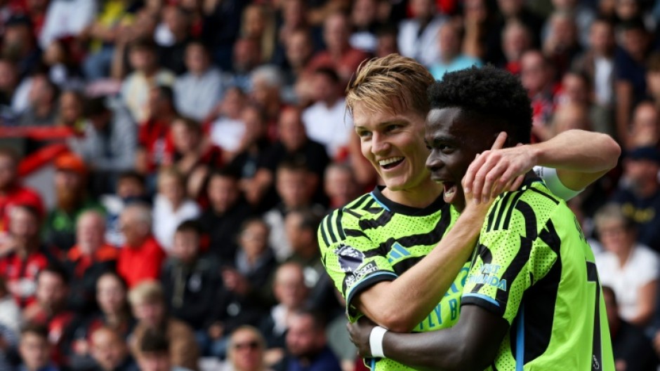 Arsenal's Martin Odegaard (L) and Bukayo Saka are dreaming of Champions League and Premier League glory