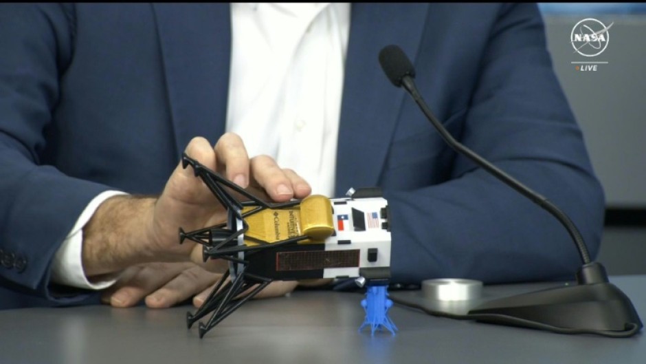 This frame grab from Nasa, shows Intuitive Machines CEO Steve Altemus holding a model of Odysseus to show its position on the side 