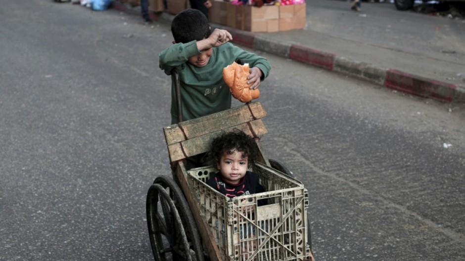 A boy pushes a makeshift buggy in Rafah, the southern Gaza Strip -- the head of the United States aid agency said Israel needed to open more crossings for aid