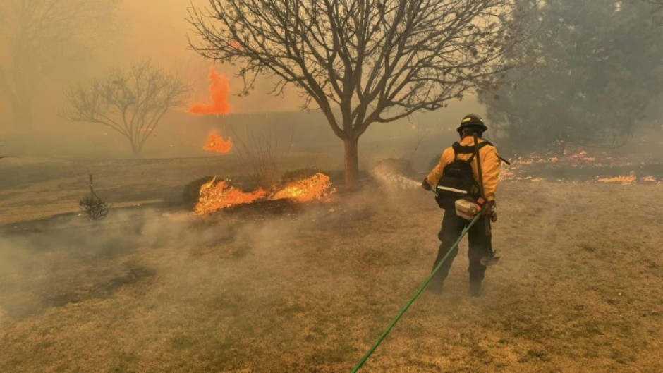 A firefighter battling the Smokehouse Creek Fire, near Amarillo, in the Texas Panhandle