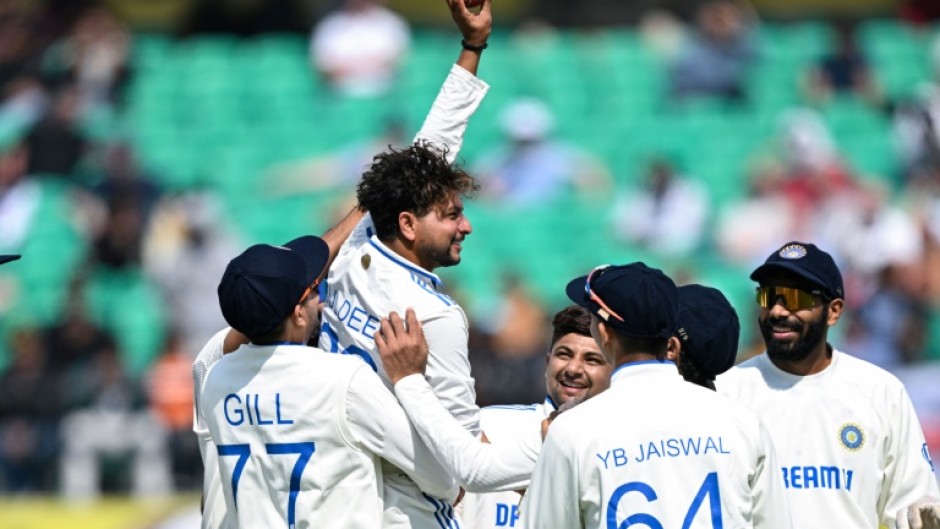 India's Kuldeep Yadav (2L) celebrates after taking five-wicket haul during the first day of the fifth Test