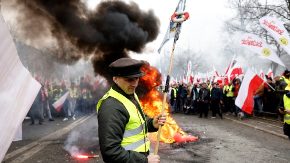 Blowing horns, throwing smoke bombs and firecrackers and lighting fires, the farmers gathered outside the prime minister's office