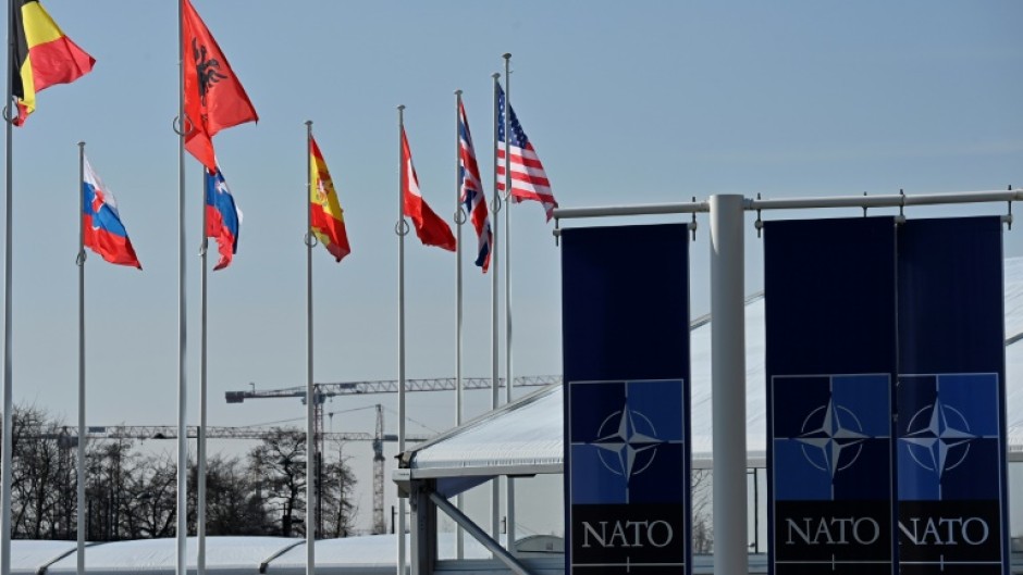 An empty mast is seen among member-nations at the NATO headquarters, ahead of a flag-raising ceremony for new member Sweden