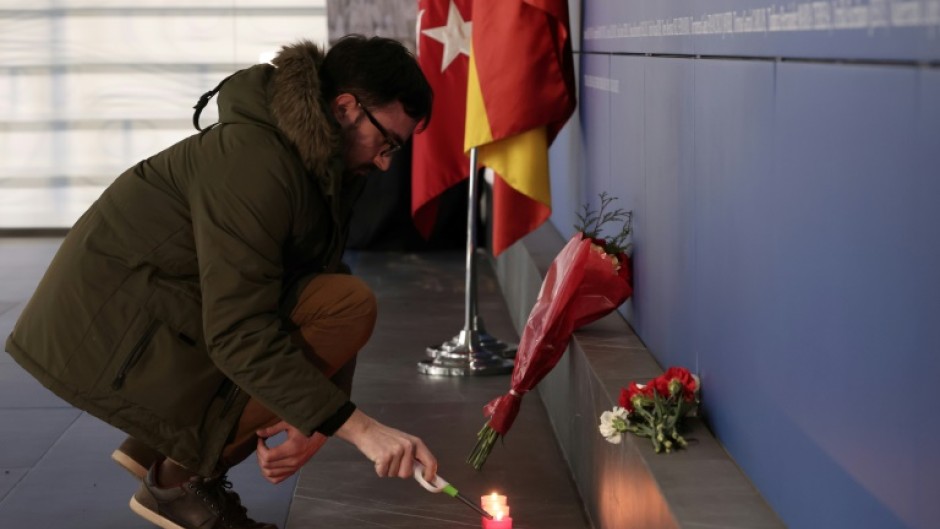 A panel bears the names of victims of the train attacks at Atocha station