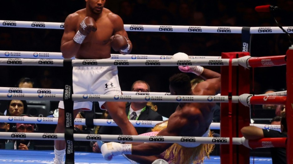 Down and almost out:  Anthony Joshua sends Francis Ngannou to the canvas