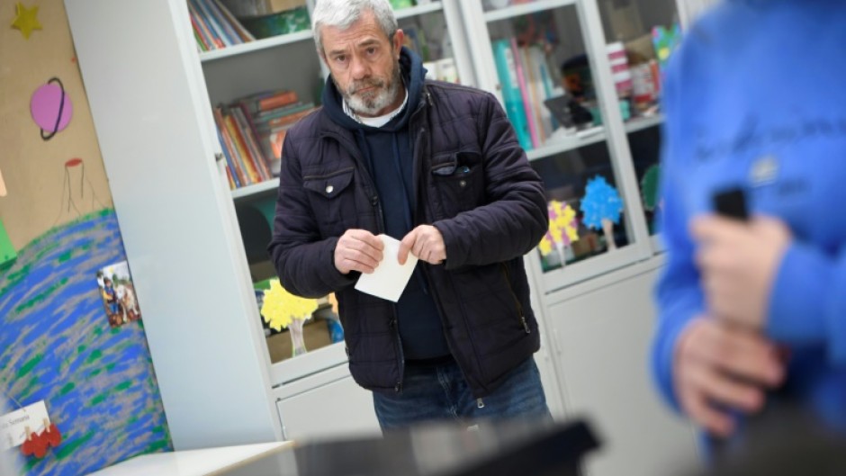 A voter waits to cast his ballot at a polling station in Espinho near Porto in northern Portugal