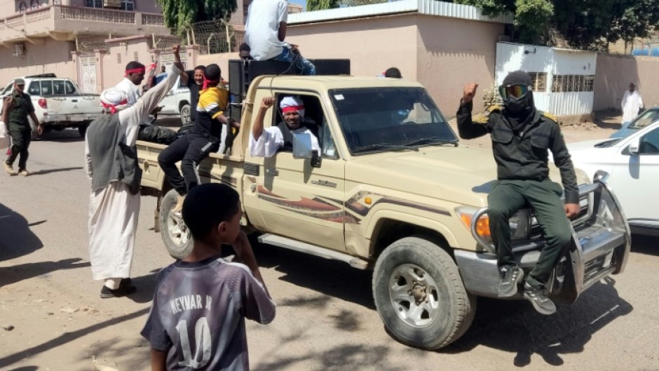 Fighters of a militia raised by Sudan's regular army patrol the streets of Gedaref