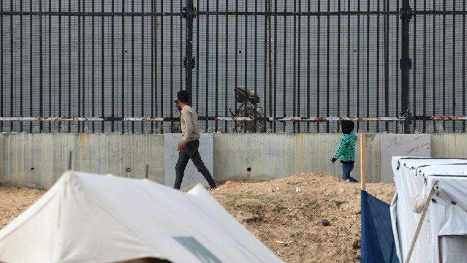 Displaced Gazans in the Rafah camps can see Egyptian soldiers on patrol just across the border fence