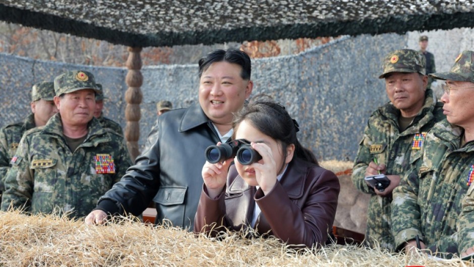 Kim Jong Un's daughter Ju Ae peers through binoculars at a recent training exercise involving North Korean paratroopers