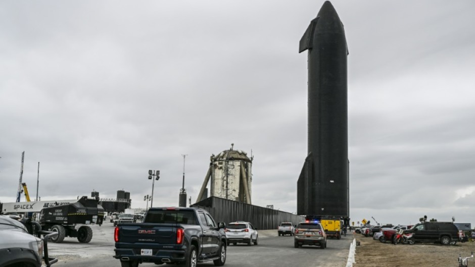 People gather as SpaceX Starship spacecraft prototype is transported from the launch site ahead of the SpaceX Starship third flight test from Starbase in Boca Chica, Texas 