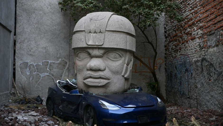 This Tesla 3 car crushed by a nine-ton Olmec-inspired head is the doing of Mexican artist Chavis Marmol