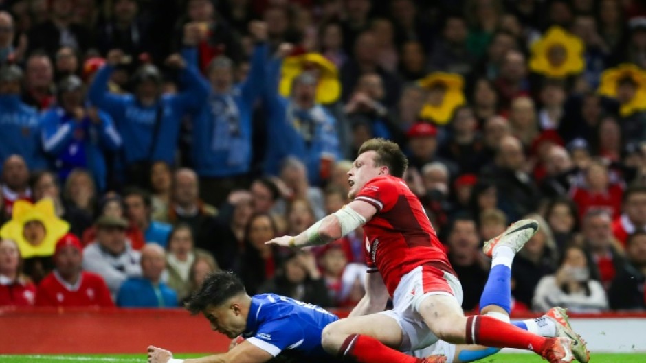 Excellent score: Italy full-back Lorenzo Pani (under L) dives across the line to score a try in a xx-x Six Nations win over Wales in Cardiff