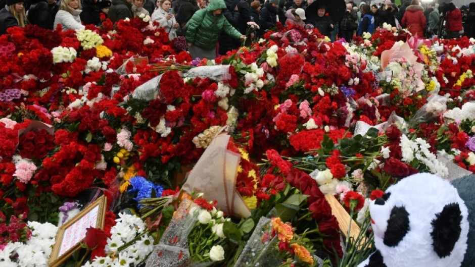 People laid flowers at a makeshift memorial in front of the site of the attack