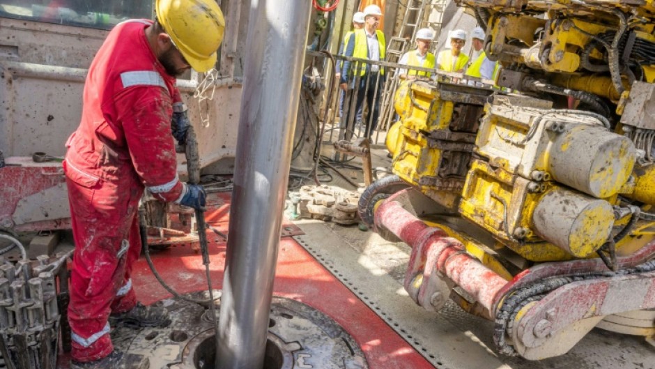 A worker operates a drill at a geothermal plant construction site in south Germany