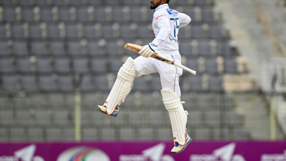 Sri Lanka's Dhananjaya de Silva celebrates after scoring a century during the third day of the first Test cricket match between Bangladesh and Sri Lanka