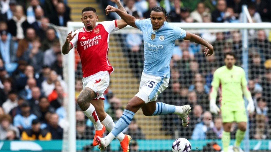 Yellow card complaint: Manchester City defender Manuel Akanji (R) in action against Arsenal's Gabriel Jesus (L) 