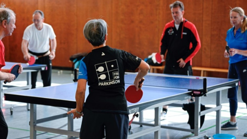 People play table tennis at the Ping Pong Parkinson initiative in Berlin on April 11, 2023, World Parkinson's Day -- the devastating disorder affects 10 million people worldwide