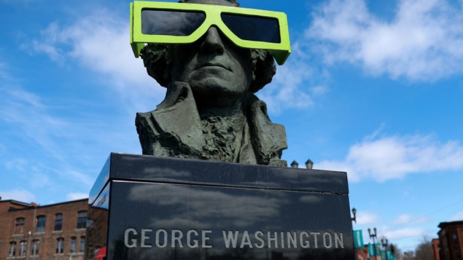 Eclipse glasses are worn by a statue of George Washington on April 07, 2024, in Houlton, Maine