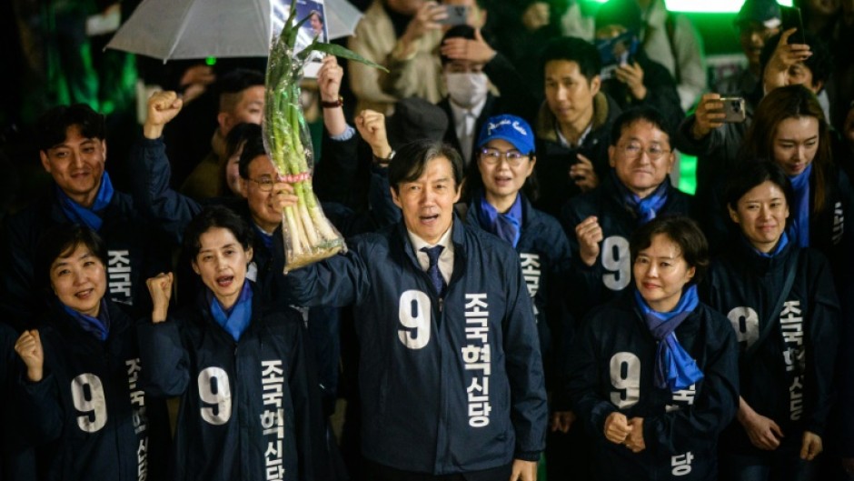 Cho Kuk, leader of the Rebuilding Korea Party, holds up green onions at a campaign event in Seoul on March 28, 2024