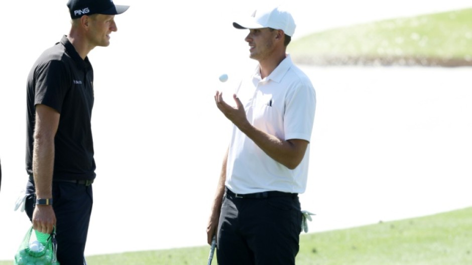 Poland's Adrian Meronk speaks with ninth-ranked Ludvig Aberg of Sweden during pracrice for the 88th Masters