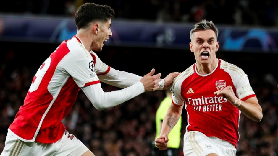 Arsenal's Leandro Trossard (R) celebrates after scoring against Bayern Munich