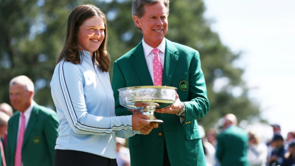 Augusta National chairman Fred Ridley presents Lottie Woad of England with the trophy following the final round of the Augusta National Women's Amateur at Augusta National Golf Club.