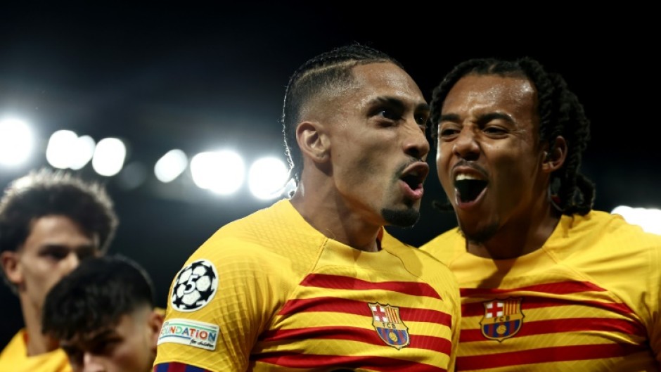 Raphinha (C) celebrates after scoring one of his two goals in Barcelona's 3-2 win over PSG