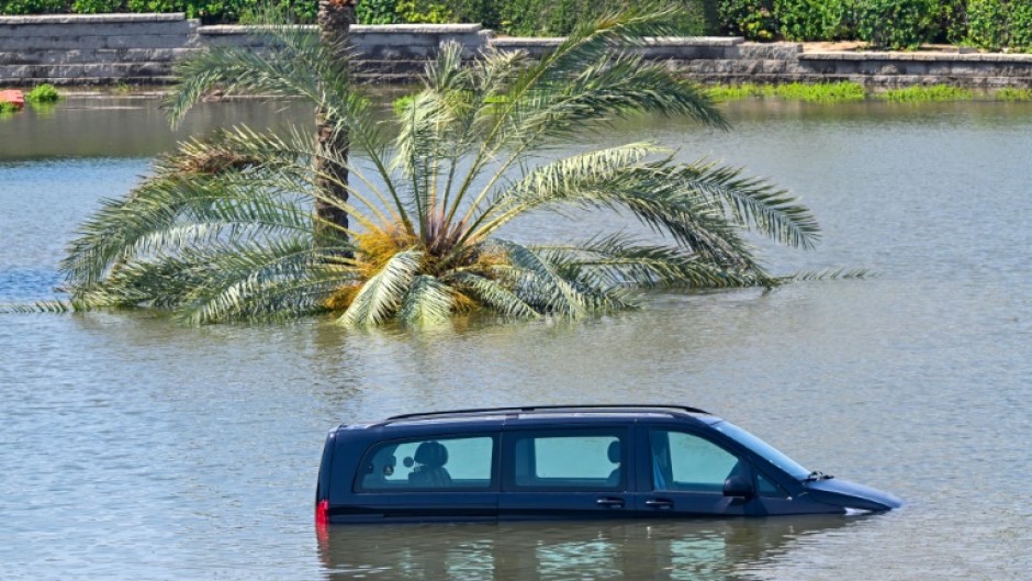 Cars are stranded on a flooded in Dubai following heavy rains on April 18, 2024