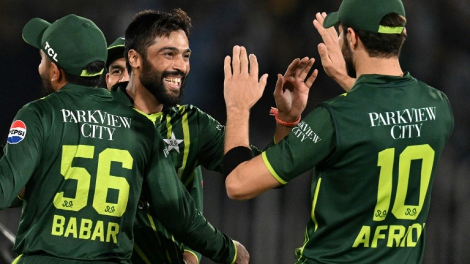 Back in business: Mohammad Amir (2L) celebrates after taking the wicket of New Zealand's Dean Foxcroft 