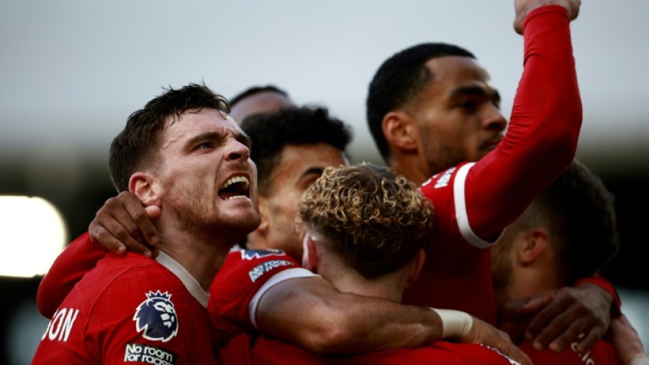 Andy Robertson (left) leads the celebrations after Liverpool's third goal 