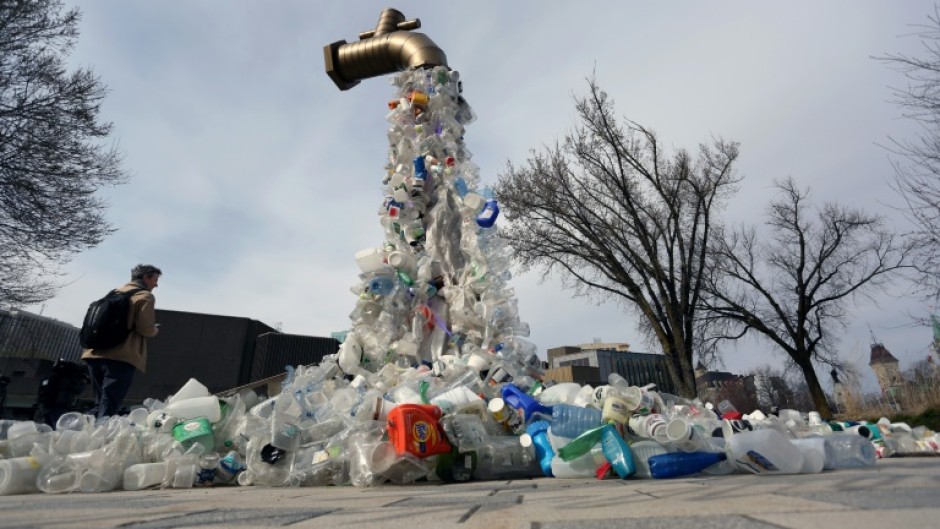 A sculpture titled "Giant Plastic Tap" by Canadian artist Benjamin Von Wong is displayed outside the fourth session of the UN Intergovernmental Negotiating Committee on Plastic Pollution that has wrapped up in Ottawa, Canada