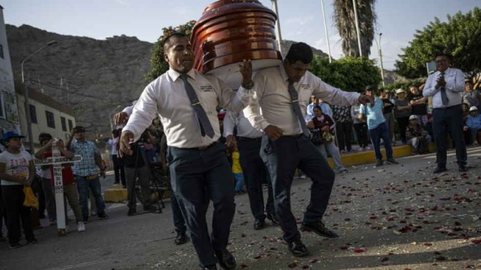 Peru's 'dancer's of death' show off intricate footwork as they bear a coffin to its final resting place 