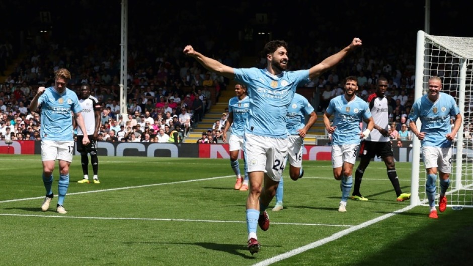 Manchester City defender Josko Gvardiol (C) celebrates scoring against Fulham